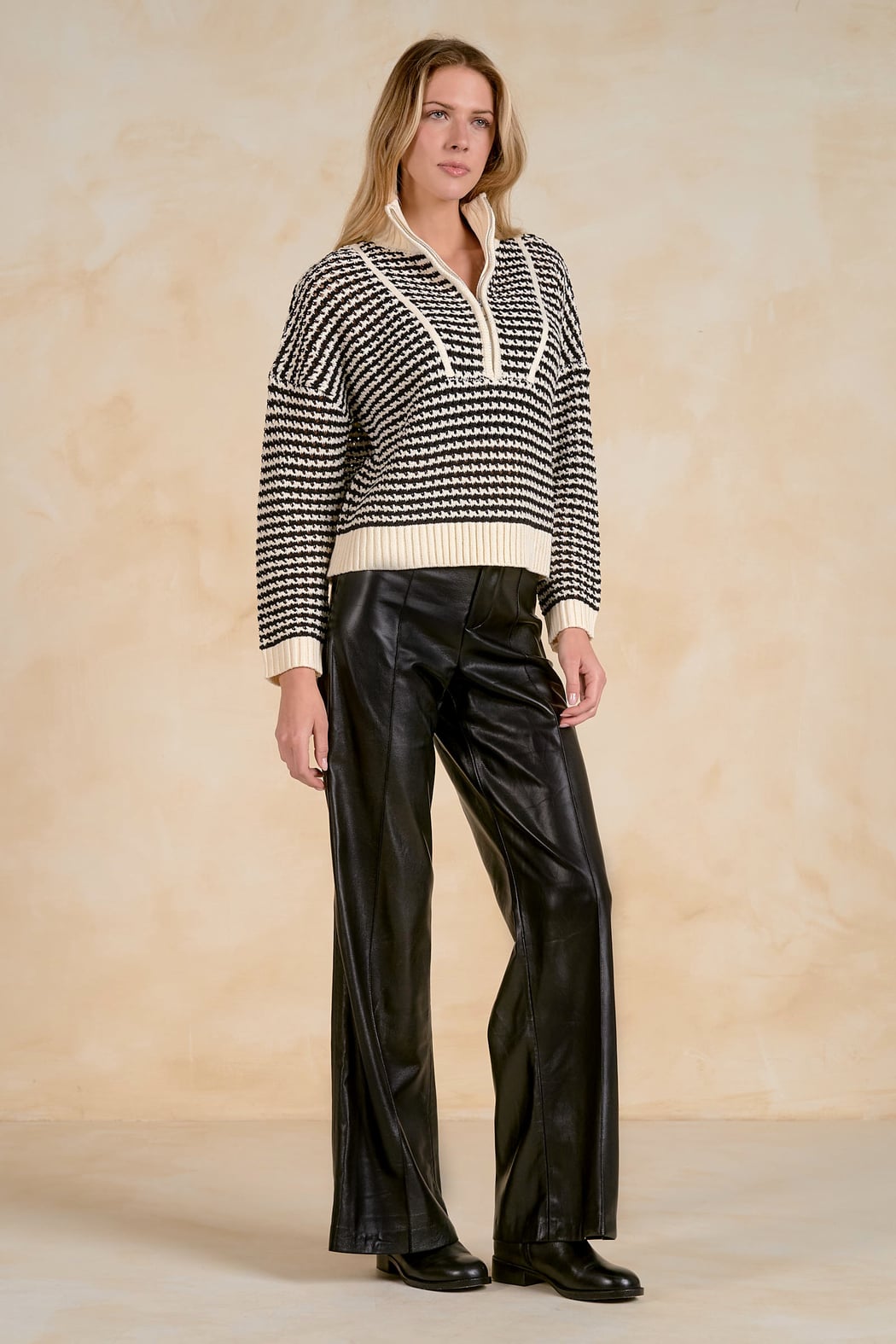 Side view of the Elan 1/4 Zip Open Knit Sweater in Black on model