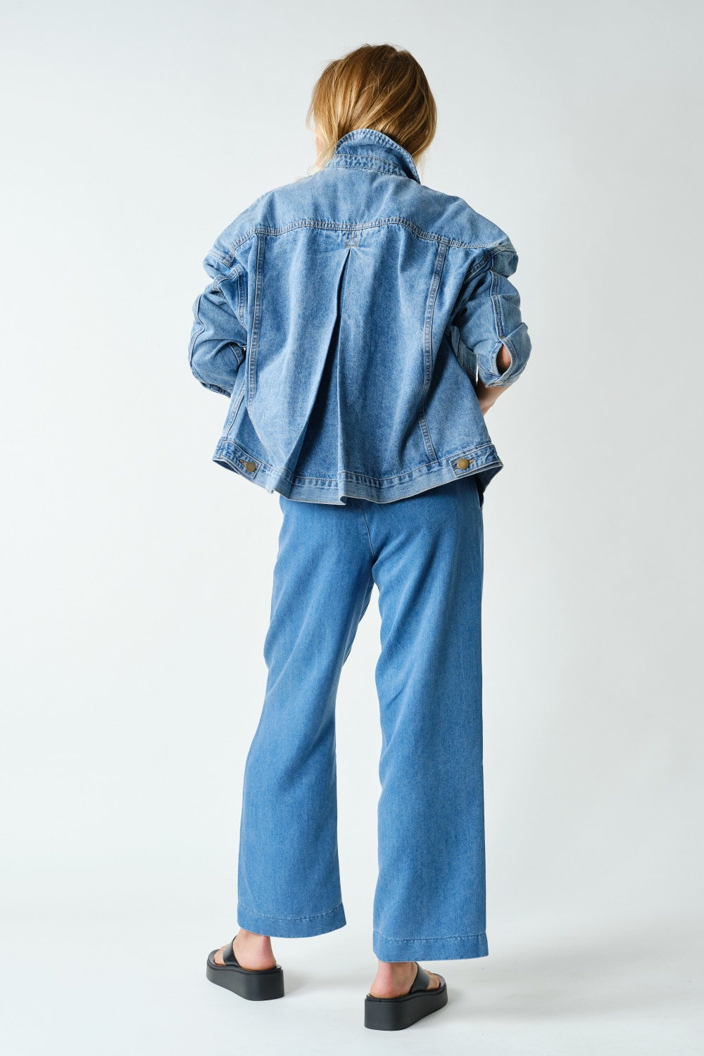 Side view of the Mono B Boxy Denim Trucker Jacket in Medium Denim.